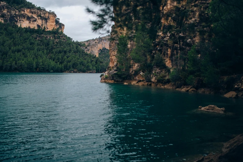 a large body of water surrounded by trees, pexels contest winner, les nabis, in spain, 2 5 6 x 2 5 6 pixels, cinematic film still, sharp cliffs