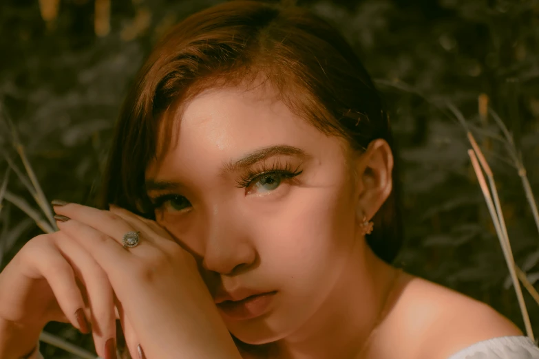 a close up of a woman with a ring on her finger, a colorized photo, inspired by Elsa Bleda, trending on pexels, young cute wan asian face, lazy eyes, dua lipa, woman posing