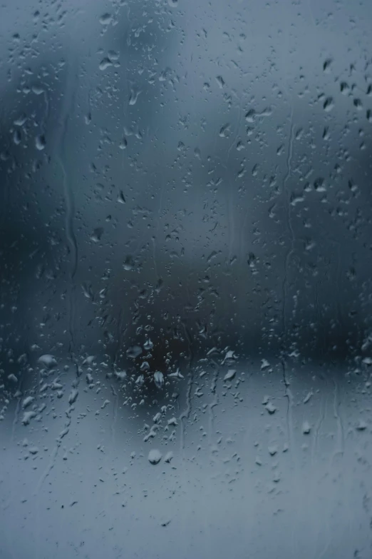 a close up of a window with rain on it, a picture, by Ryan Pancoast, pexels contest winner, blue and gray colors, humid ground, today\'s featured photograph 4k, promo image