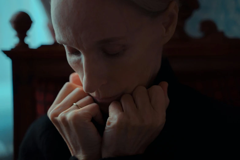 a close up of a person with a hand on their chin, an album cover, inspired by Nan Goldin, unsplash, hyperrealism, carmen dell ’ orefice, 2 0 2 1 cinematic 4 k framegrab, kneeling in prayer, gillian anderson