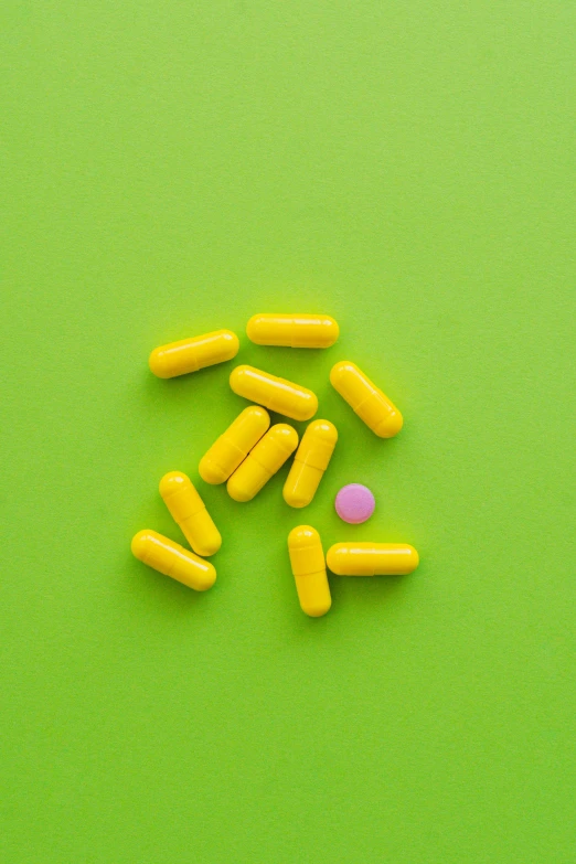 yellow and pink pills on a green background, by Sven Erixson, pexels, antipodeans, minimalist photorealist, yellow purple green black, made of nanomaterials, instagram picture