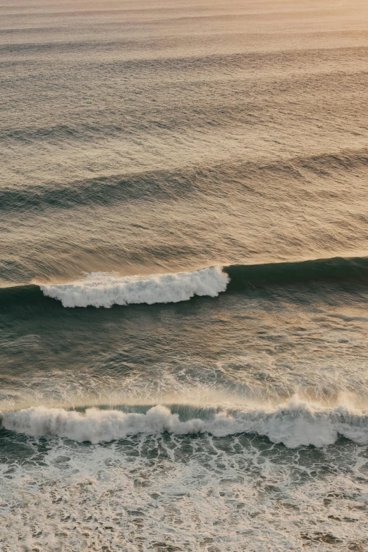 a person riding a surfboard on top of a wave, as far as the eye can see, south african coast, slide show, sundown