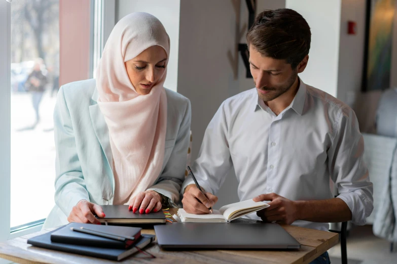 a man and a woman are sitting at a table, trending on pexels, hurufiyya, white hijab, academic clothing, holding notebook, thumbnail