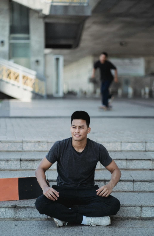 a man sitting on the steps with a skateboard, inspired by Ryan Yee, bangkok townsquare, confident looking, smooth in the background, parkour