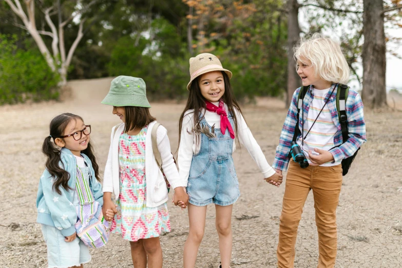 a group of young children standing next to each other, trending on pexels, hollister ranch, multicolored, female explorer mini cute girl, aboriginal australian hipster