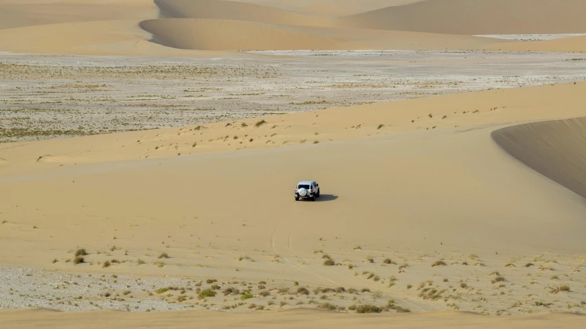 a jeep driving in the middle of a desert, by Daniel Seghers, pexels contest winner, hurufiyya, sandy beach, whealan, 2000s photo