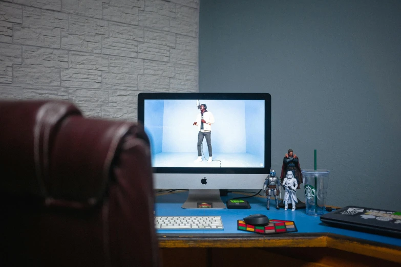 a computer monitor sitting on top of a wooden desk, a hologram, inspired by Scott Listfield, unsplash, video art, movie still from star wars, cinematic outfit photo, in claymation, studio shot