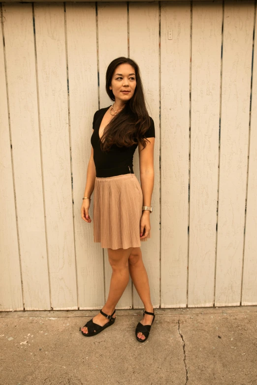 a woman standing in front of a white wall, reddit, renaissance, pleated miniskirt, 15081959 21121991 01012000 4k, asian female, full body photograph