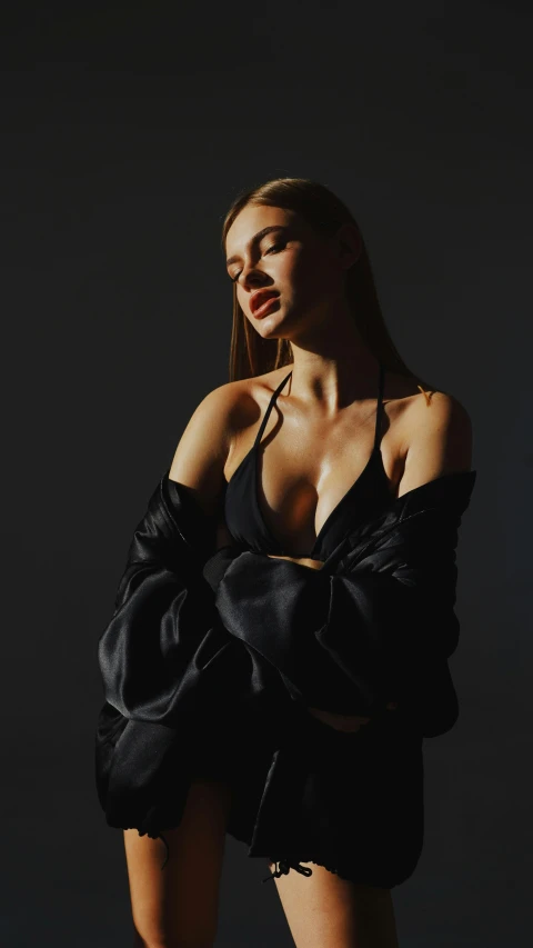 a woman in a black dress posing for a picture, an album cover, inspired by Elsa Bleda, trending on pexels, renaissance, bralette, silk robes, portrait sophie mudd, soft volumetric studio lighting