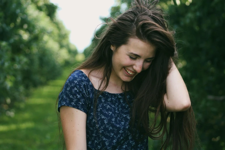 a woman that is standing in the grass, pexels contest winner, natural brown hair, [[[[grinning evily]]]], photo of a model, small hairs