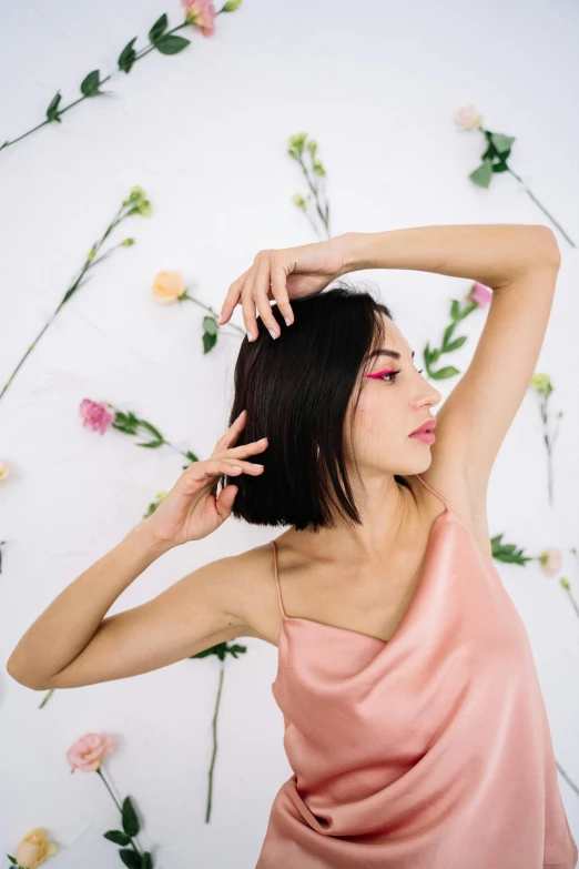a woman in a pink dress posing for a picture, an album cover, inspired by Ina Wong, trending on pexels, bob cut hair, floral growth, armpit, minimalistic