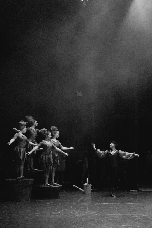 a black and white photo of a group of dancers, magical realism, theatre equipment, peter pan, 1990s photograph, [ cinematic