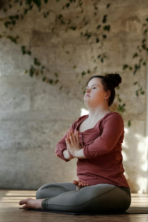 a woman sitting on the floor in a yoga pose, trending on pexels, renaissance, an obese, doing a prayer, non-binary, brown