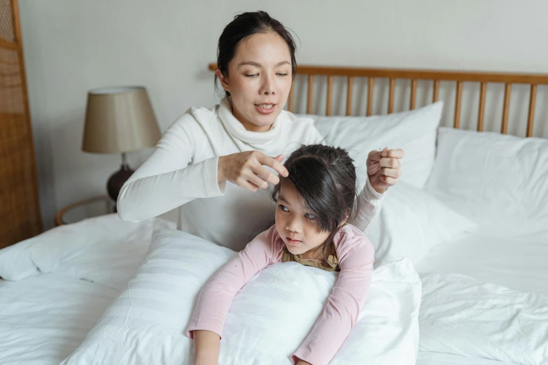 a woman combing a little girl's hair on a bed, a cartoon, pexels contest winner, hurufiyya, wearing nanotech honeycomb robe, south east asian with long, wearing spiky, cold temperature