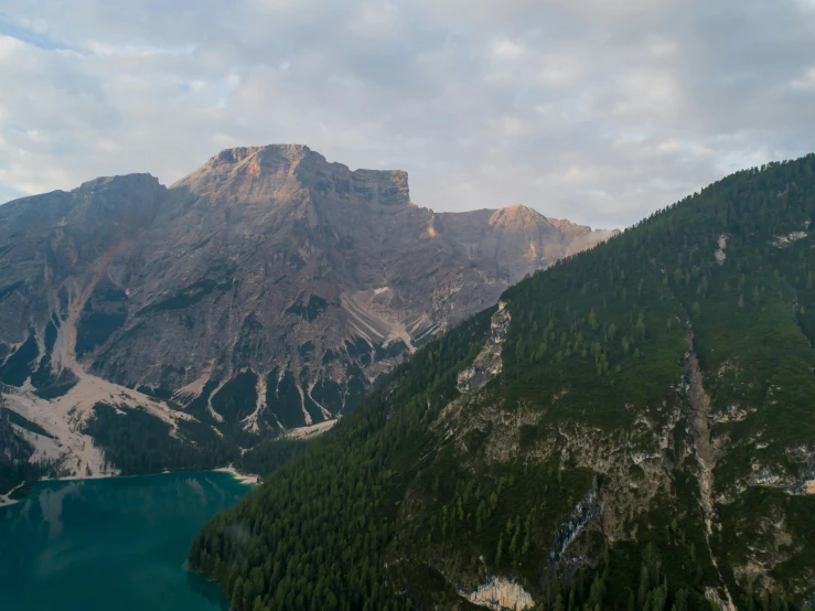 a large body of water surrounded by mountains, by Carlo Martini, pexels contest winner, fan favorite, drone footage, early evening, dolomites