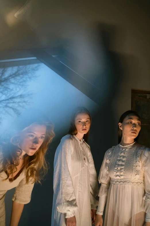 a group of women standing next to each other in a room, an album cover, unsplash, renaissance, southern gothic scene, horror movie lighting, skies, ( ( theatrical ) )