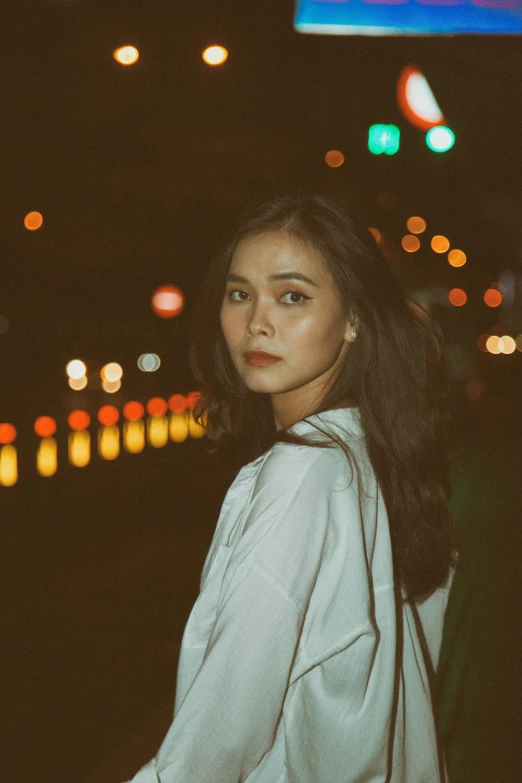 a woman standing on a city street at night, pexels contest winner, realism, portrait of modern darna, slightly minimal, south east asian with round face, handsome girl