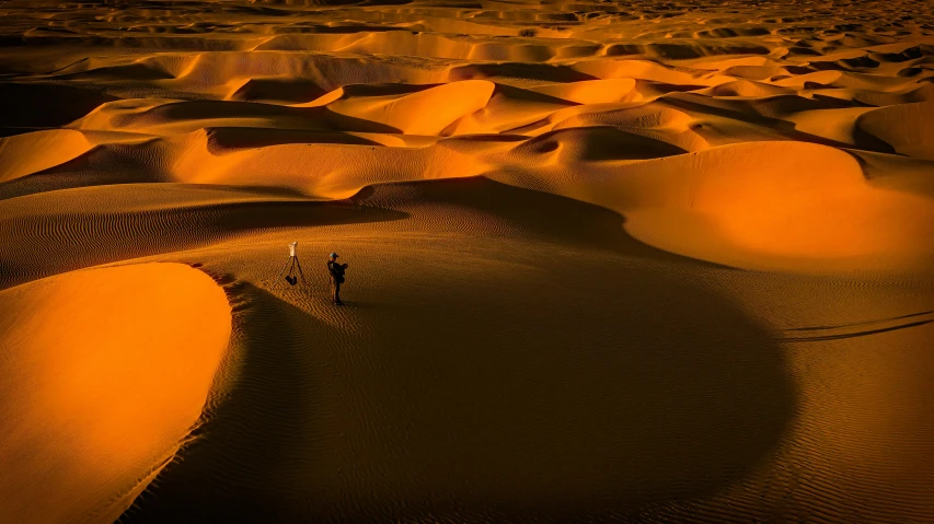 a couple of people walking across a desert, pexels contest winner, les nabis, orange glow, deep colour, highly detailed 8k, sand banks