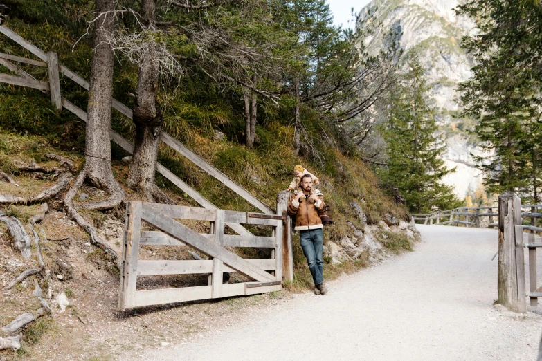 a man and a woman standing in front of a gate, by Amalia Lindegren, pexels contest winner, dolomites, lumberjack, standing in road, 2 5 6 x 2 5 6 pixels