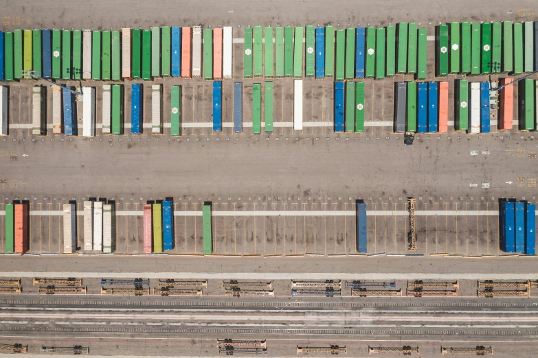 a train yard filled with lots of colorful containers, a portrait, inspired by Andreas Gursky, unsplash, hegre, knolling, ignant, a green