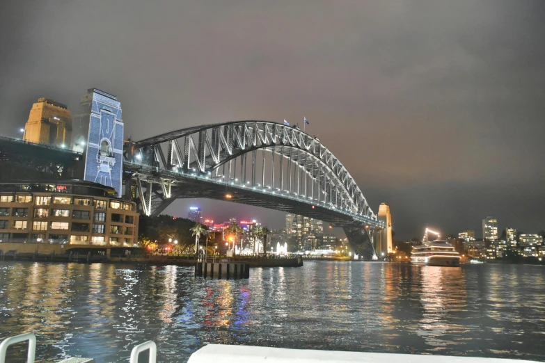 a large bridge over a body of water, a hologram, inspired by Sydney Carline, happening, photo taken from a boat, northern star at night, grey, ready to eat