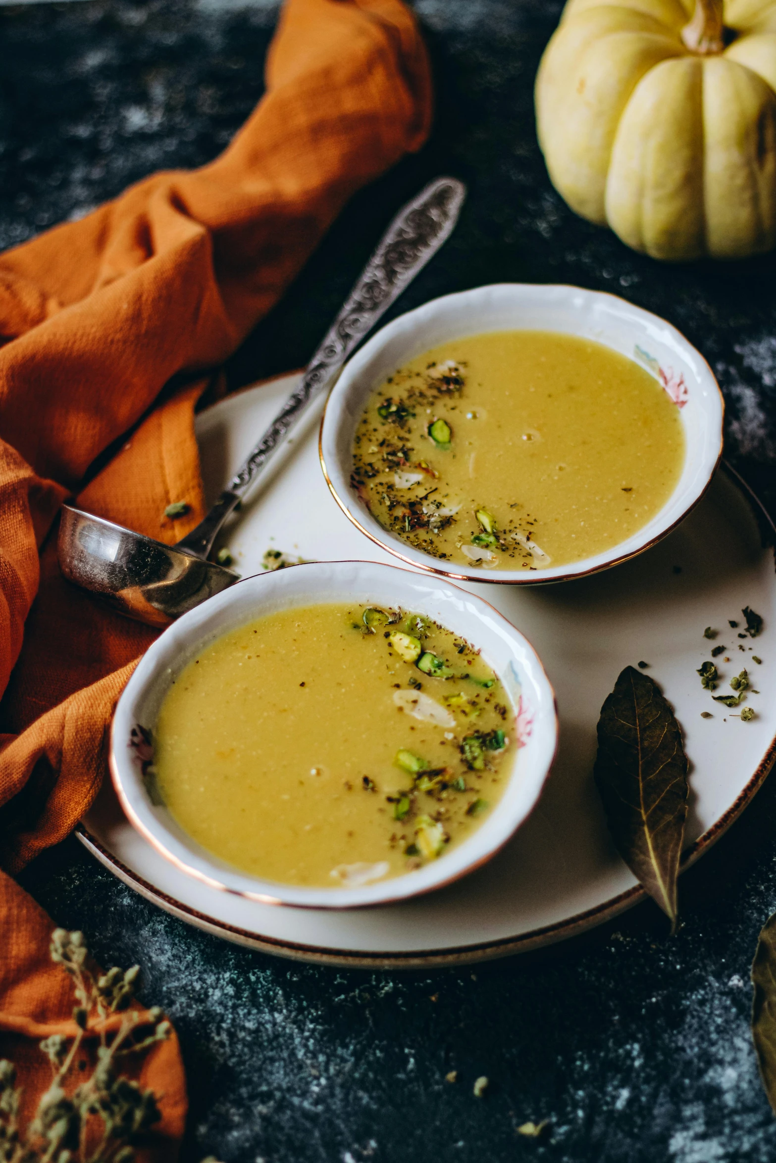 two bowls of soup sitting on top of a plate, by Julia Pishtar, pumpkins, mustard, thumbnail, middle eastern