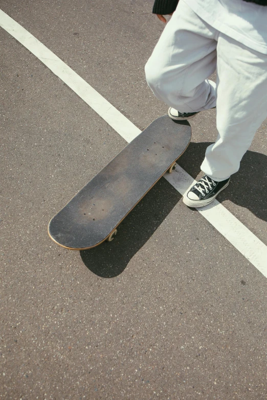a man riding a skateboard across a parking lot, by Niko Henrichon, close-up on legs, low quality photo, game ready, 1 2 9 7