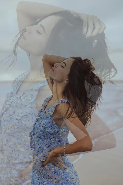 a woman standing on top of a beach next to the ocean, by Carey Morris, trending on pexels, photorealism, double exposure of love, brunette woman, floral dream, blue mood