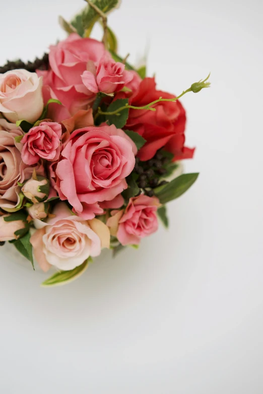 a bouquet of pink and red roses on a white surface, a still life, inspired by François Boquet, trending on unsplash, made of flowers, porcelain skin ”, soft and detailed, swirling