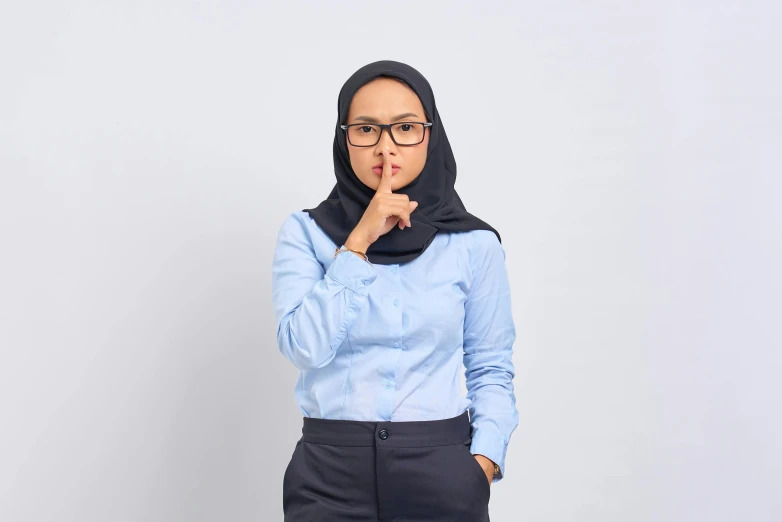 a woman in a blue shirt and black pants, by Basuki Abdullah, shutterstock, hurufiyya, pursed lips, wearing correct era clothes, wearing a suit and glasses, secret <