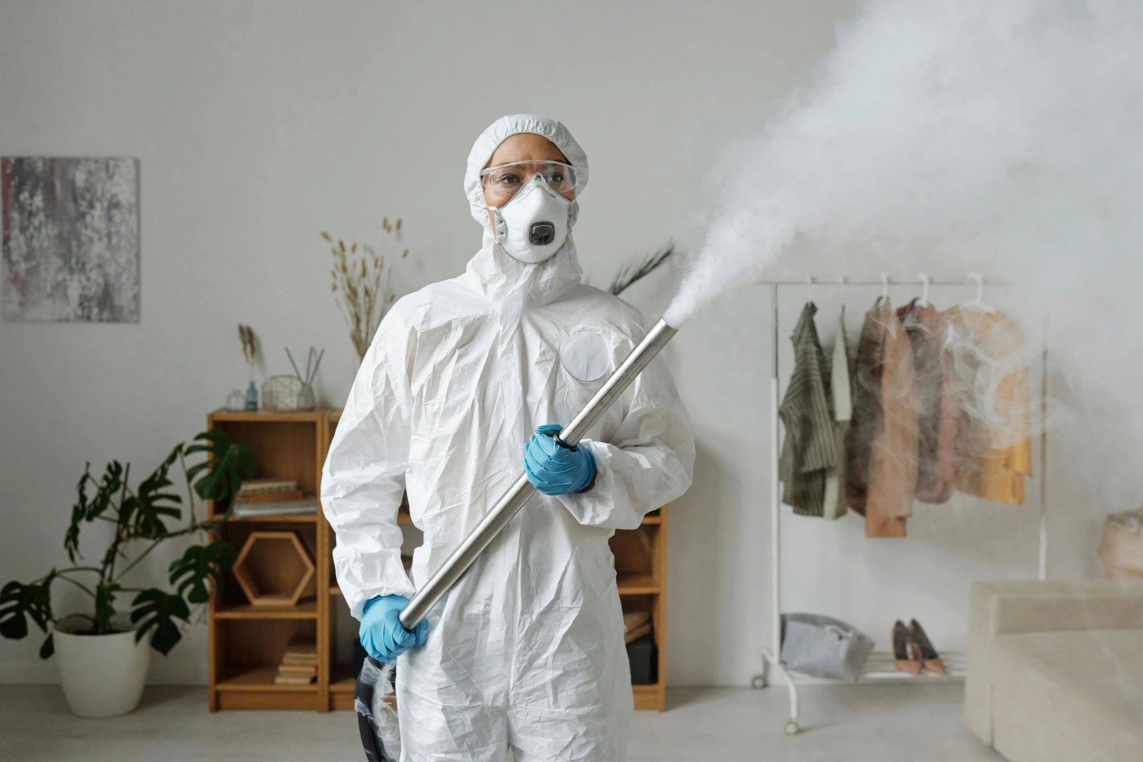 a man in a hazmat suit holding a stick with smoke coming out of it, pexels contest winner, sterile minimalistic room, avatar image, wearing plumber uniform, wearing lab coat and a blouse