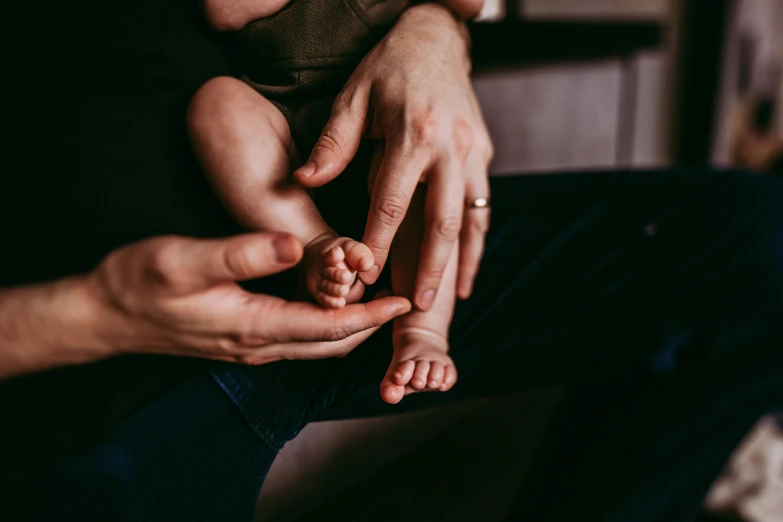 a close up of a person holding a baby, feet and hands, frank moth, soft lighting and focus, instagram post