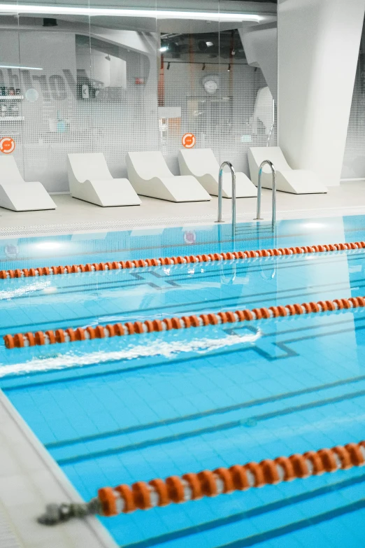 a swimming pool filled with lots of blue water, physicality-based render, orange and white color scheme, dingy gym, depth haze