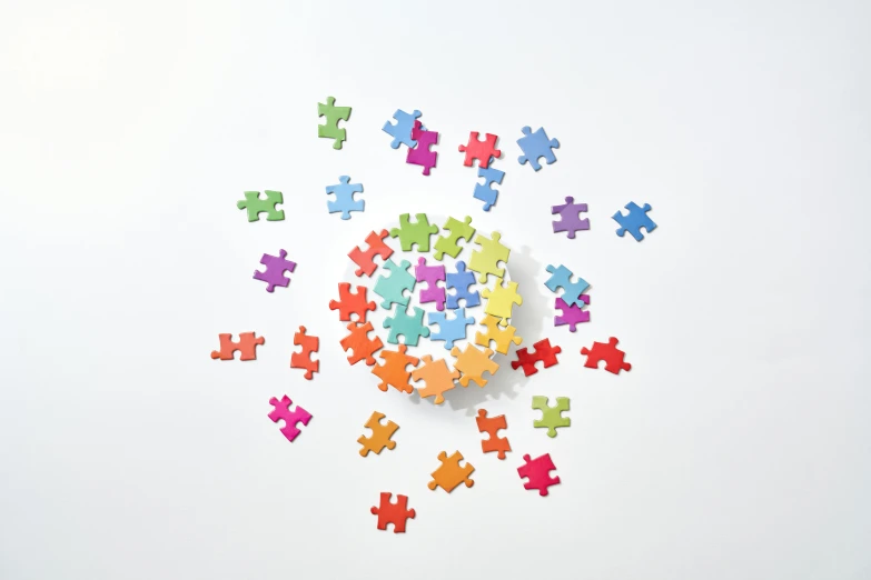 a clock made out of puzzle pieces on a white surface, a jigsaw puzzle, inspired by Damien Hirst, soft rainbow, taken on iphone 1 3 pro, light scatter, product view