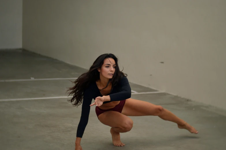 a woman is doing a trick on a skateboard, unsplash, arabesque, contemporary dance, low quality photo, portrait of maci holloway, kneeling