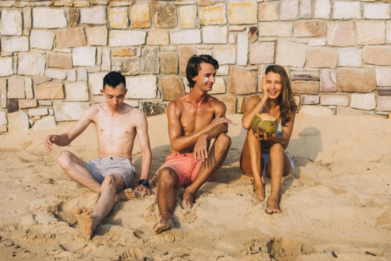 a group of people sitting on top of a sandy beach, sydney sweeney, avatar image