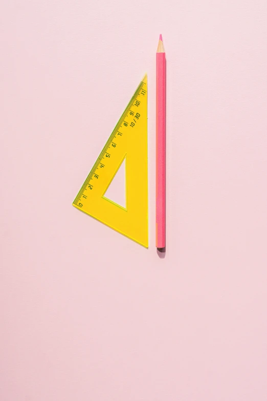 a pencil and ruler on a pink surface, by Julia Pishtar, visual art, triangle, colors: yellow, promo image, high-resolution