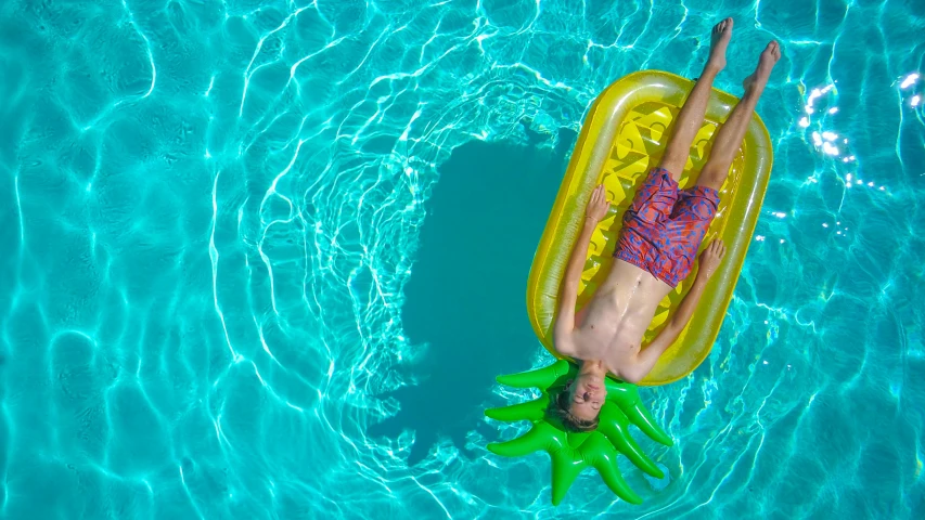 a person floating in a pool on an inflatable raft, by Carey Morris, pexels contest winner, cute boy, top down shot, full width, 15081959 21121991 01012000 4k