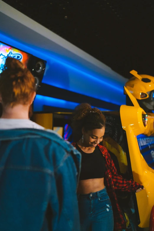 a group of people playing a video game, bumblebee, yellow and blue, revellers, large robot