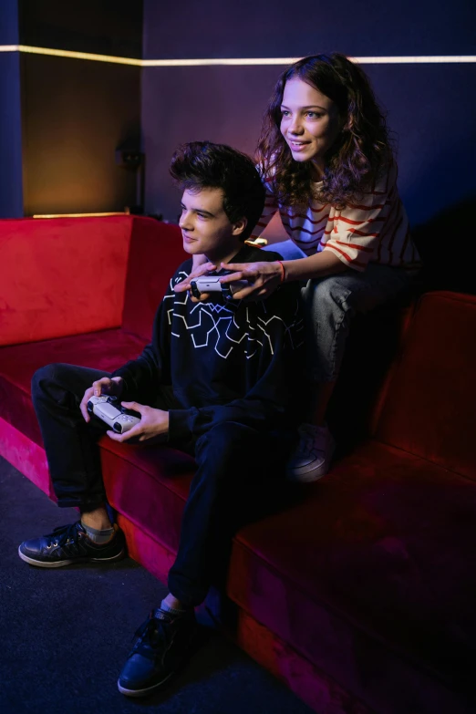 a couple of people sitting on top of a red couch, holding controller, dafne keen, game ready, high quality photo