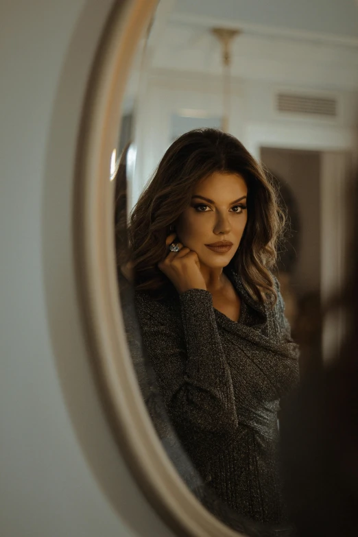 a woman standing in front of a mirror talking on a cell phone, pexels contest winner, renaissance, attractive brown hair woman, portait of haifa wehbe, wearing a dark sweater, mirror hallways