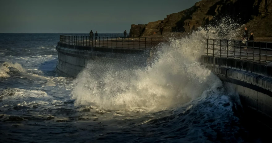 a man riding a surfboard on top of a wave, by Peter Churcher, pexels contest winner, happening, near a jetty, marsden, people angling at the edge, standing in a maelstrom