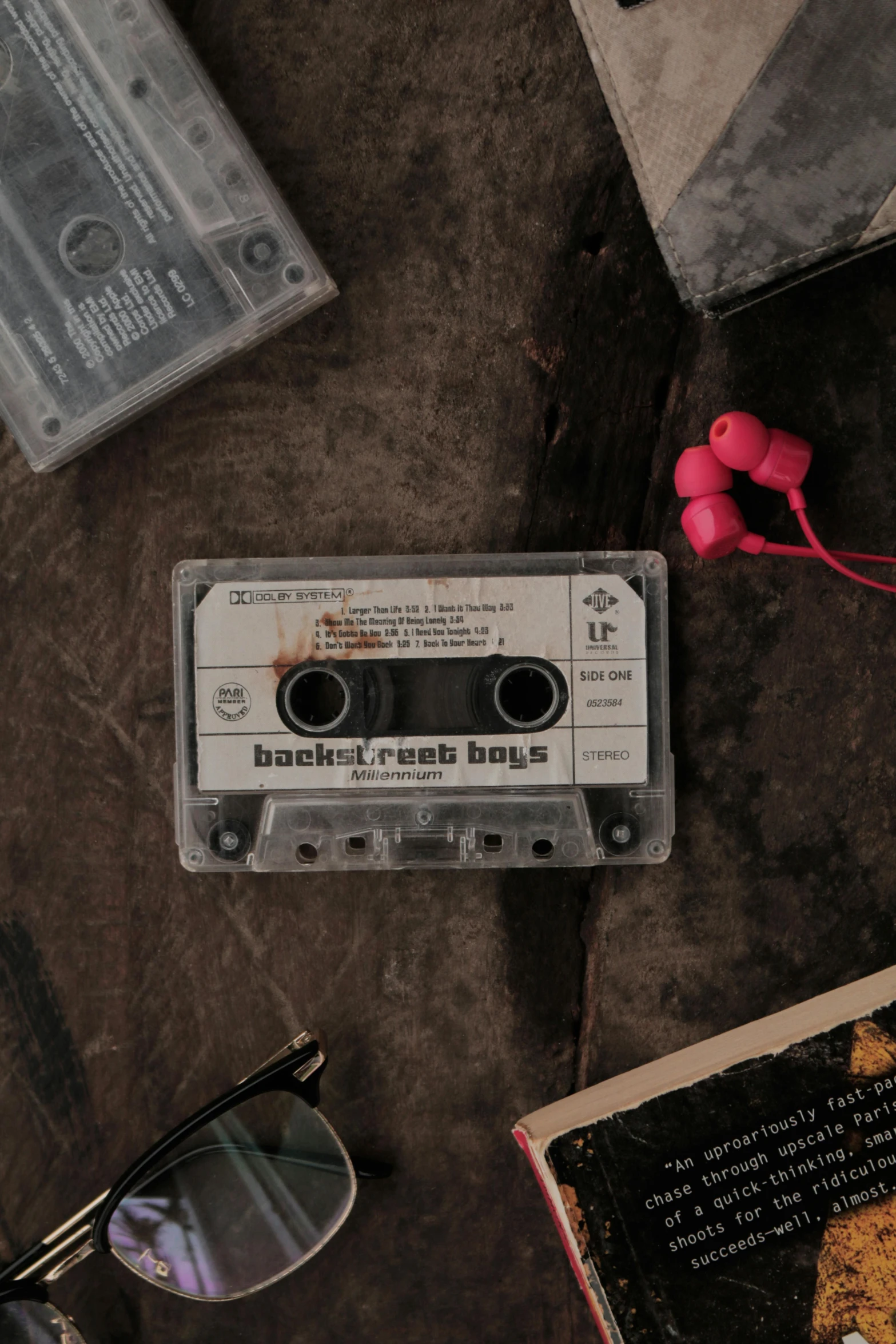 a couple of cassettes sitting on top of a table, an album cover, inspired by Elsa Bleda, trending on pexels, backstreet boys, earbuds, grunge aesthetic, ( ( theatrical ) )