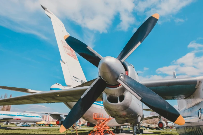 a propeller plane sitting on top of a grass covered field, by Alexander Fedosav, pexels contest winner, modernism, retro spaceships parked outside, museum background, thumbnail, engines