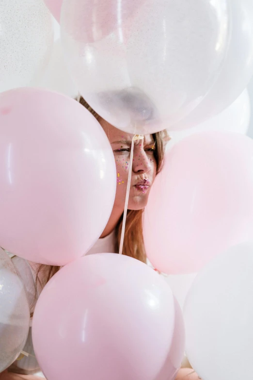 a woman holding a bunch of pink and white balloons, large pores, portrait featured on unsplash, parties, shy looking down