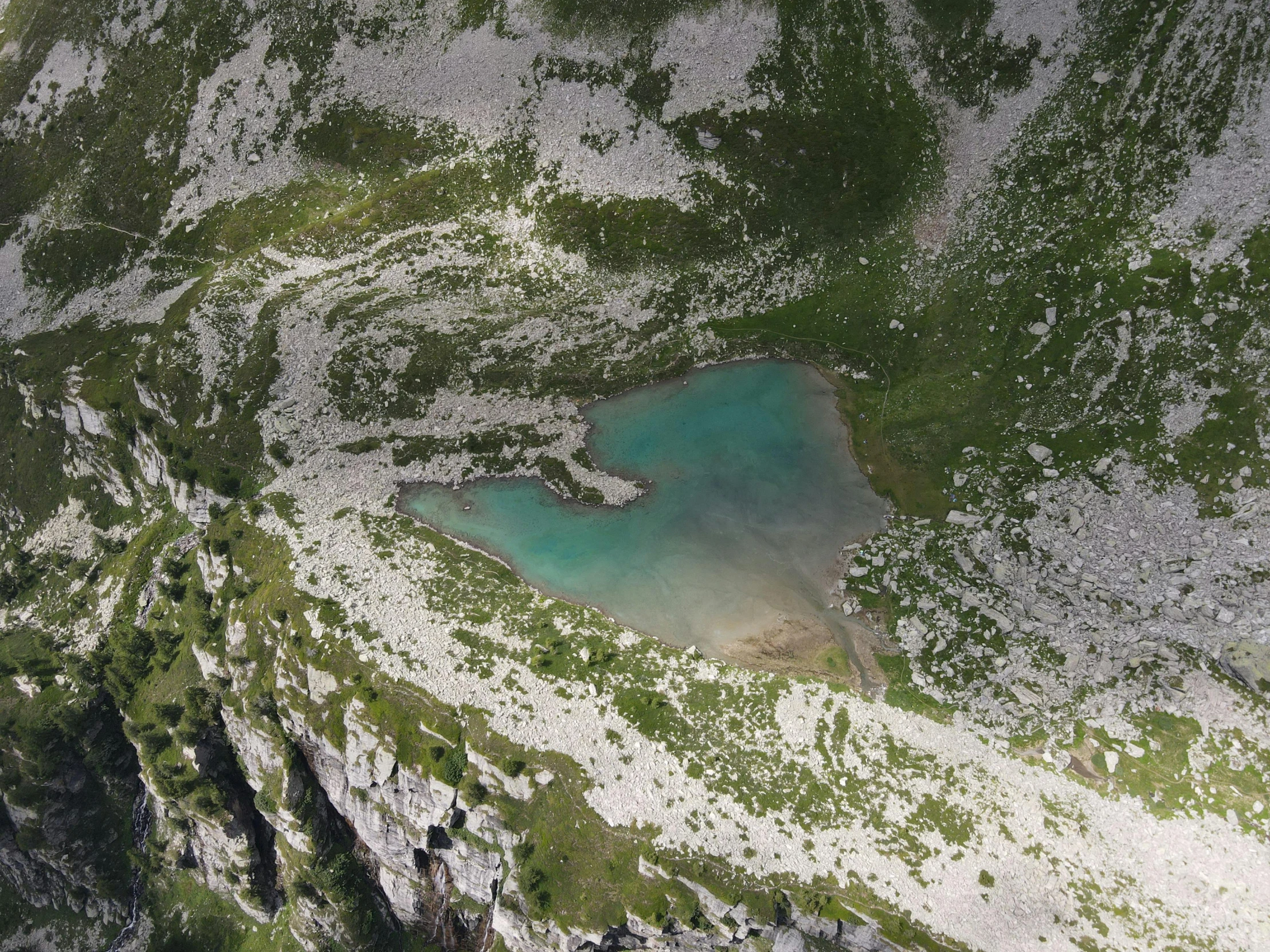 an aerial view of a lake in the mountains, by Emma Andijewska, pexels contest winner, hurufiyya, over a chalk cliff, ponds, shade, 1 5 0 4