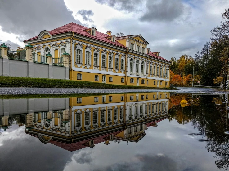 a large building sitting next to a body of water, inspired by Konstantin Vasilyev, pexels contest winner, baroque, square, october, northern finland, high quality picture