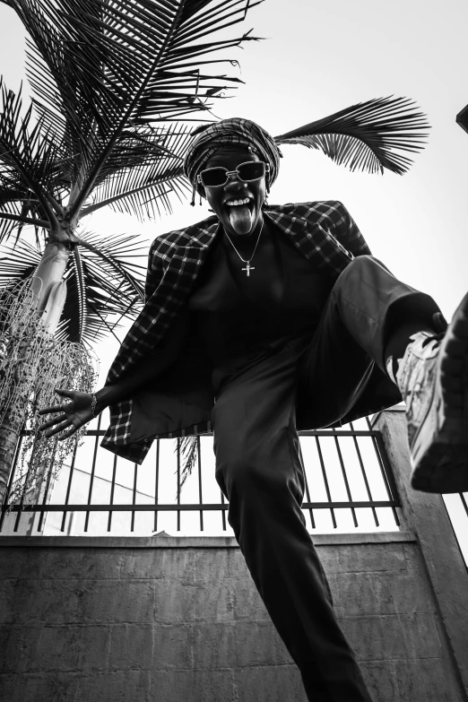 a man flying through the air while riding a skateboard, a black and white photo, by Charly Amani, unsplash, funk art, uganda knuckles, standing astride a gate, while smiling for a photograph, reggae