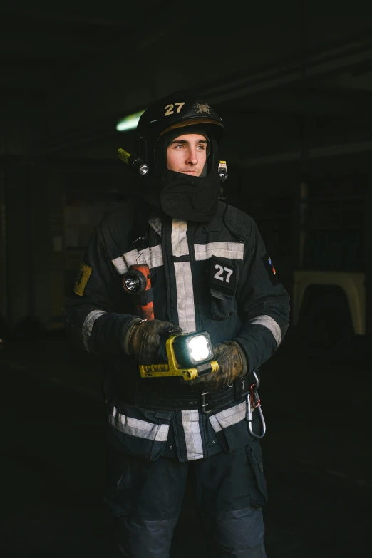a firefighter standing in a garage holding a flashlight, a portrait, by Adam Marczyński, worksafe. instagram photo, lachlan bailey, 278122496, caucasian