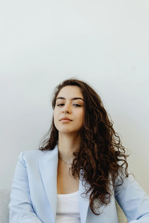 a woman sitting on a couch with her eyes closed, trending on pexels, renaissance, pokimane, headshot profile picture, rebecca sugar, wearing suit